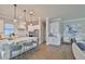 Modern kitchen with white cabinets, large island, and stainless steel appliances at 2919 W Elrod Ave, Tampa, FL 33611