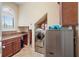 Spacious laundry room with washer, dryer, and built-in cabinets at 3341 Gulf Blvd, Belleair Beach, FL 33786