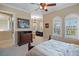 Bedroom with a queen-size bed, built-in dresser, and a sitting area with a desk at 3341 Gulf Blvd, Belleair Beach, FL 33786