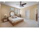 Bright bedroom featuring a king-size bed, ceiling fan, and large windows at 3341 Gulf Blvd, Belleair Beach, FL 33786