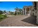 Large home with a paved driveway and lush landscaping at 3341 Gulf Blvd, Belleair Beach, FL 33786