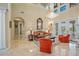 Spacious living room with high ceilings and a large chandelier at 3341 Gulf Blvd, Belleair Beach, FL 33786