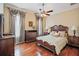Bright bedroom with hardwood floors and a large bed at 3341 Gulf Blvd, Belleair Beach, FL 33786