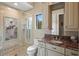 Bathroom with a walk-in shower and granite vanity at 3341 Gulf Blvd, Belleair Beach, FL 33786