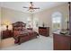 Spacious bedroom with a queen-size bed, ceiling fan, and plenty of natural light at 3341 Gulf Blvd, Belleair Beach, FL 33786