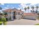 Grand two-story home with a tile roof and three-car garage at 3341 Gulf Blvd, Belleair Beach, FL 33786