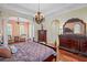 Main bedroom with hardwood floors, sitting area and chandelier at 3341 Gulf Blvd, Belleair Beach, FL 33786