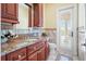 Bathroom features granite vanity, tiled floors, and a private door at 3341 Gulf Blvd, Belleair Beach, FL 33786