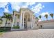 Impressive two-story home with columns and a grand entrance at 3341 Gulf Blvd, Belleair Beach, FL 33786