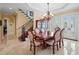 Formal dining room with hardwood floors, chandelier, and French doors at 3341 Gulf Blvd, Belleair Beach, FL 33786