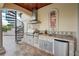 Luxury outdoor kitchen with grill, sink, and mini-refrigerator at 3341 Gulf Blvd, Belleair Beach, FL 33786