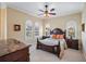 Well-lit bedroom with a queen-size bed and arched windows with plantation shutters at 3341 Gulf Blvd, Belleair Beach, FL 33786