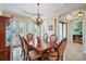 Formal dining room with hardwood floors, chandelier and French doors at 3341 Gulf Blvd, Belleair Beach, FL 33786