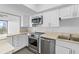 Updated kitchen featuring stainless steel appliances and white cabinetry at 500 N Osceola Ave # 802, Clearwater, FL 33755