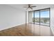 Bedroom with hardwood floors, ceiling fan, and access to a balcony at 500 N Osceola Ave # 802, Clearwater, FL 33755
