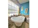 Bathroom with soaking tub and stone tile accents at 26240 Willow St, Brooksville, FL 34601