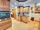 Kitchen with oak cabinets, granite counters, and a corner pantry at 26240 Willow St, Brooksville, FL 34601