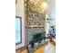 Rustic stone fireplace with wood mantel in a living room setting at 26240 Willow St, Brooksville, FL 34601