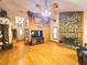 Bright living area with hardwood floors, stone fireplace, and views to the front entry at 26240 Willow St, Brooksville, FL 34601