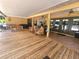 Spacious covered back porch with wooden deck and a hammock at 26240 Willow St, Brooksville, FL 34601