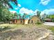 Charming two-story house with stone accents and a green roof at 26240 Willow St, Brooksville, FL 34601