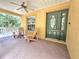 Inviting front porch with wooden chairs and a view of the nature at 26240 Willow St, Brooksville, FL 34601