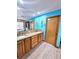 Double vanity bathroom with granite countertops and blue walls at 26240 Willow St, Brooksville, FL 34601