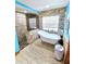Bathroom with soaking tub, walk-in shower, and stone tile at 26240 Willow St, Brooksville, FL 34601
