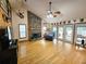 Spacious living room with stone fireplace, hardwood floors, and access to backyard patio at 26240 Willow St, Brooksville, FL 34601