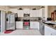 Well-equipped kitchen featuring white cabinets and granite countertops at 13285 Crest Lake Dr, Hudson, FL 34669