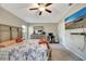 Main bedroom with a king-size bed, TV, and ensuite bathroom at 13285 Crest Lake Dr, Hudson, FL 34669