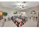 Living room with sectional sofa, ottoman, and large TV at 13285 Crest Lake Dr, Hudson, FL 34669