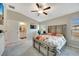 Main bedroom with ensuite bathroom and a comfortable bed at 13285 Crest Lake Dr, Hudson, FL 34669