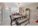 Dining area with table, bench, and access to kitchen at 13285 Crest Lake Dr, Hudson, FL 34669