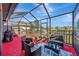 Spacious screened patio with seating area and grill at 13285 Crest Lake Dr, Hudson, FL 34669