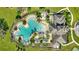 Aerial view of resort-style community pool with expansive deck and adjacent clubhouse at 13285 Crest Lake Dr, Hudson, FL 34669