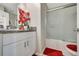 Clean bathroom with granite countertop, white cabinets and a shower/tub combo at 13285 Crest Lake Dr, Hudson, FL 34669