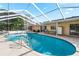 Inviting screened pool with lake view at 8067 Tranquil Dr, Spring Hill, FL 34606