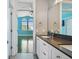Updated bathroom with double vanity, dark countertop and white cabinets at 348 Larboard Way, Clearwater, FL 33767
