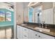 Modern bathroom with double vanity, dark countertop and white cabinets at 348 Larboard Way, Clearwater, FL 33767