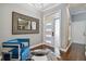 Elegant entryway with a blue chair, large mirror and hardwood floors at 348 Larboard Way, Clearwater, FL 33767