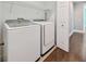 Convenient laundry room with Samsung washer and dryer and overhead shelving at 348 Larboard Way, Clearwater, FL 33767