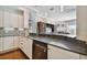 Modern kitchen with white cabinets, stainless steel appliances and granite countertops at 348 Larboard Way, Clearwater, FL 33767