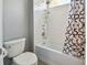Updated bathroom with white subway tile, shower/tub combo, and patterned shower curtain at 348 Larboard Way, Clearwater, FL 33767