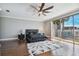 Bright bedroom with hardwood floors, a ceiling fan, and sliding glass doors to a balcony at 348 Larboard Way, Clearwater, FL 33767