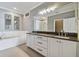 Bathroom with double vanity, large mirror, and dark countertop at 348 Larboard Way, Clearwater, FL 33767