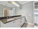 Double vanity bathroom with granite countertops and large mirror at 348 Larboard Way, Clearwater, FL 33767