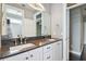 Bathroom with double vanity, dark countertop, and white cabinets at 348 Larboard Way, Clearwater, FL 33767