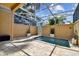 Private plunge pool with covered patio and stone tile at 348 Larboard Way, Clearwater, FL 33767