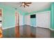 Spacious bedroom with hardwood floors, ceiling fan, and ample closet space at 348 Larboard Way, Clearwater, FL 33767